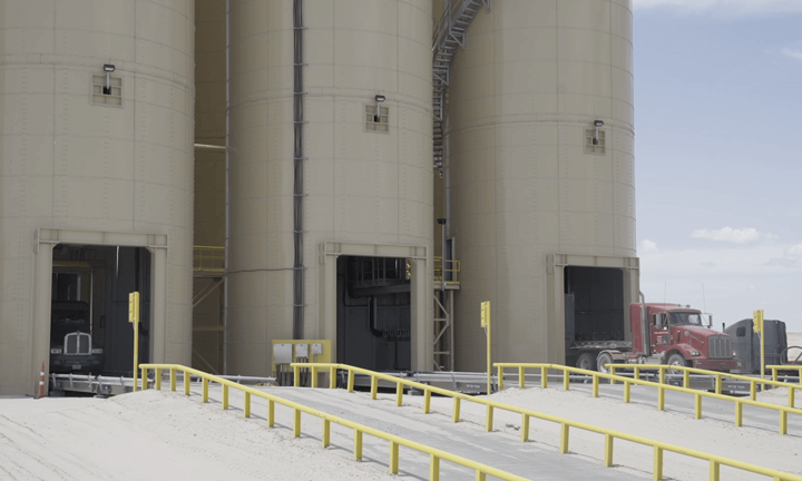 Trucks Exiting the Frac Sand Silos of Black Mountian Sand's Vest Mine in the Permian Basin